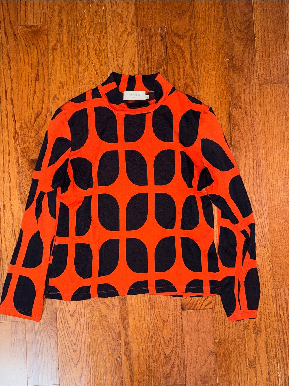 Thinking MU Trash Art & Love Mock Neck Long-Sleeve  in Orange and Black